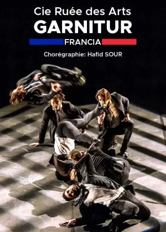 Grafika. Plakat. Zdjęcie tańczących mężczyzn w garniturach. Nad nimi na czarnym tle napis: Cie Ruee des Arts. Garnitur. Francja.