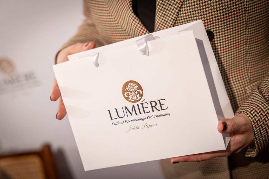 Zdjęcie. Papierowa torba z logo gabinetu Kosmetologii Profesjonalnej Lumiere.